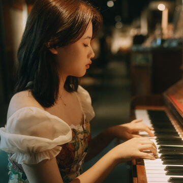 young woman playing piano