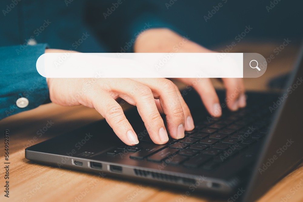 Poster Mature man hand working with laptop computer on table in his home. Search the Internet with an empty search bar. Best SEO search networking, Searching browsing internet data information concept.