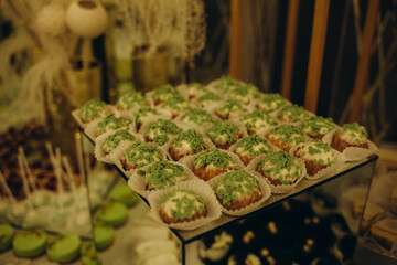 Wedding decorations. Reception. Buffet. Fruits and cheese on plates with bread in boxes. Food bar decorated by flowers and lanters