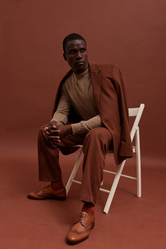 Man in suit sitting on chair