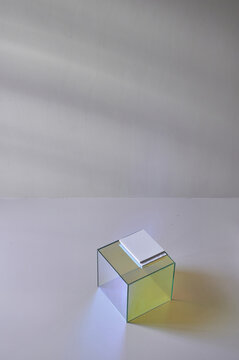 Notepad on cube in white room