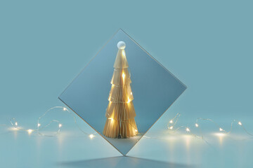 Paper Christmas tree decorated with garland.