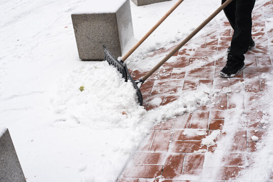 Man Cleaning snow in Winter