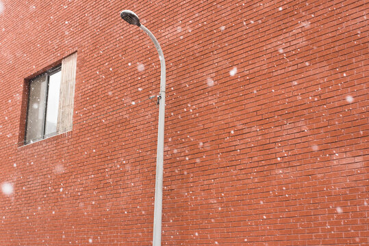 Street light on the brick wall in Winter