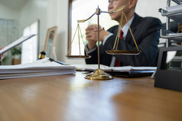 Obraz premium Judge gavel with Justice lawyers having team meeting at law firm background. Concepts of Law and Legal services.