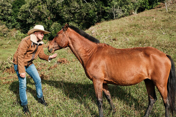 Cowboy talking to horse