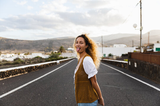 Woman standing in the middle of a road