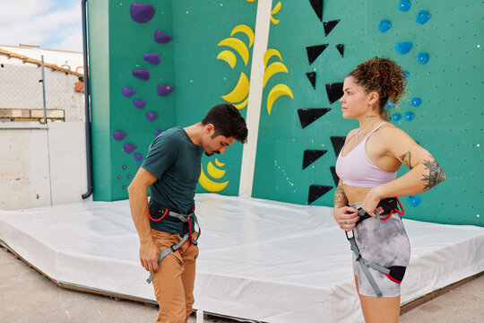 Young climbers adjusting harness