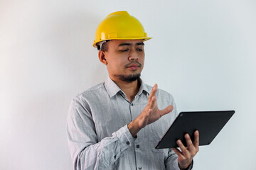 Asian manager civil engineer in uniform hard hat holding clipboard working in studio isolated white background.
