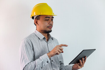 Asian manager civil engineer in uniform hard hat holding clipboard working in studio isolated white background.
