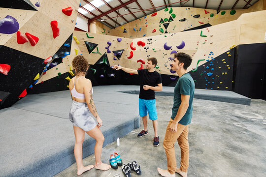 Climbers talking in bouldering gym
