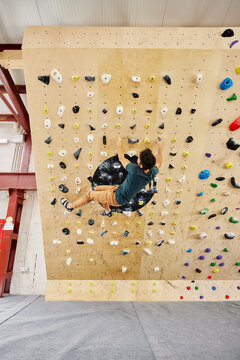 Male athlete climbing wall