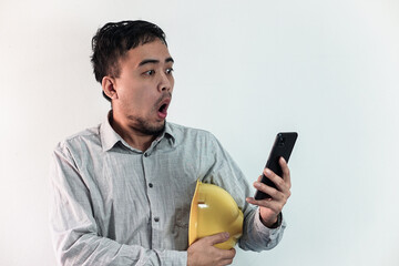 Asian manager civil engineer in uniform hard hat holding clipboard working in studio isolated white background.
