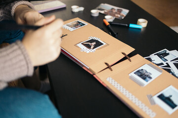 Woman making a scrapbook with polaroid photos