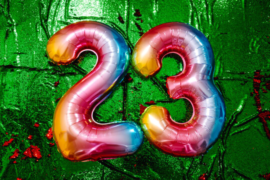 number 23 on a green sequin fabric