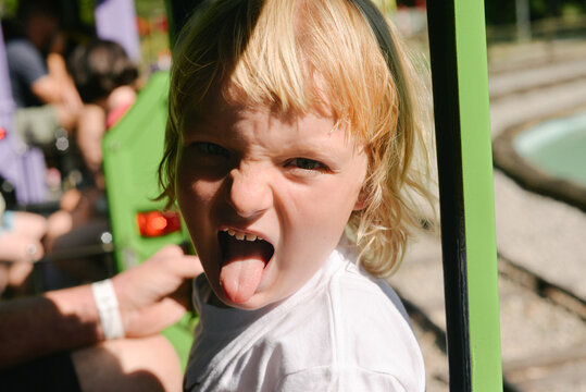 a kid sticking his tongue