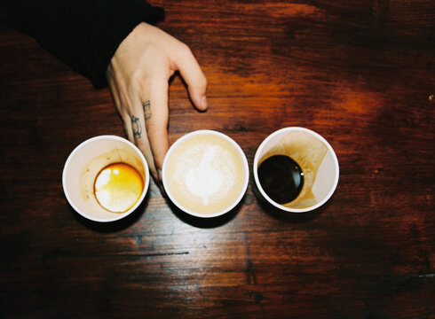 Man's hand with coffee cups