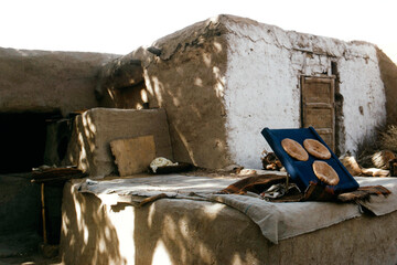 Loafs of Bread in Front of Adobe Home