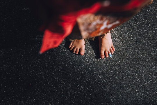 Low section of girl standing on road