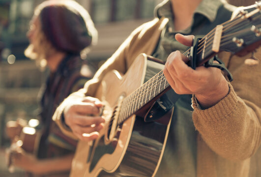 Two musicians busk on the street