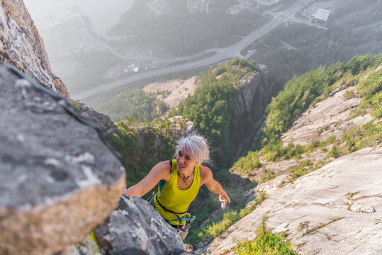 Rock climber climbing hard route on the Chief in Squamish