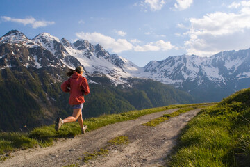 A woman running on a dirt road in Courmayer Italy