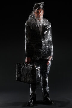 Businessman wrapped in Plastic