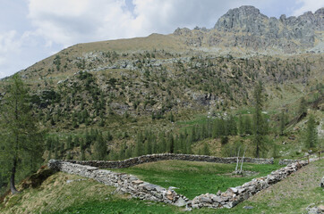 Fototapeta na wymiar Rural life. Stone fence for cattle in the mountains