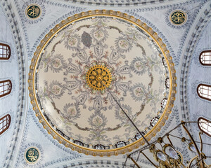 Istanbul, Turkey - April 20, 2022. Interior of prayer hall in the Nusretiye Mosque. Dome with painting, Ottoman baroque style. Arabic text as decor (verses in Arab from Koran, muslim Holy book)