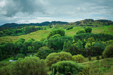 Classic New Zealand Landscape with green rolling hills under cloudy sky. Greys Hill Lookout, Gisborne, North Island, New Zealand