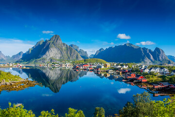 Fototapeta na wymiar Perfect reflection of the Reine village on the water of the fjord in the Lofoten Islands, Norway