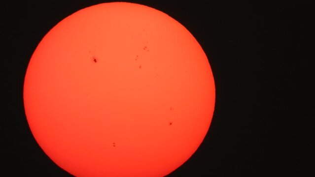 CLoseup sun in sky - black dots .
