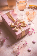 Fototapeta na wymiar Rose sparkling wine, french macarons and box of chocolates for Valentime, mothers day or birthday