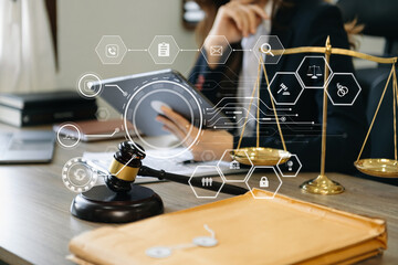 justice and law concept.Male judge in a courtroom  the gavel, working with smart phone and laptop and digital tablet computer on wood table in morning light .