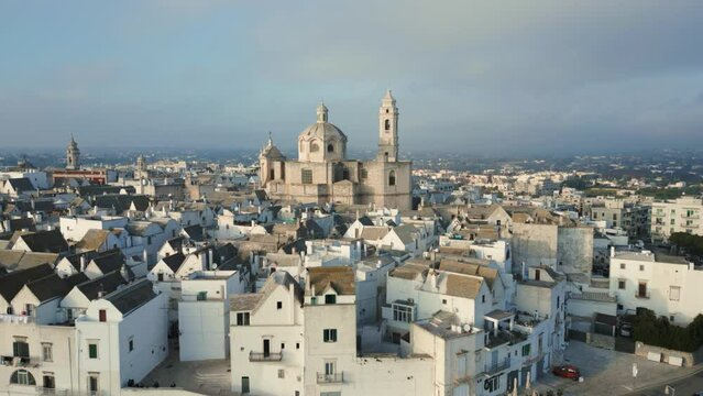 Drone shot of the old medieval town of Locorotondo in Italy. Drone slowly flying around the city. Wide shot