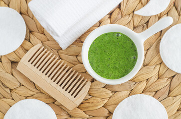 Homemade matcha green tea (kelp, algae, spirulina) face or hair mask (scrub) in a small white bowl...