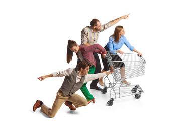 Group of excited emotional young people, office employees pushing shopping cart on white...
