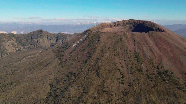 Orbiting aerial view towards Mount Vesuvius peak, South Italy on sunny day