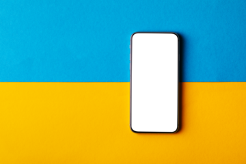 empty screen mobile phone on the background of the flag of ukraine