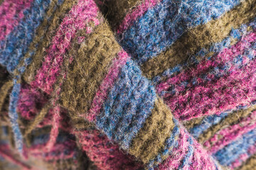 Knitted wool texture - rough knitted woolen blanket in different colors, close up