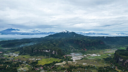 Fototapeta na wymiar Aerial view of a beautiful landscape view of Harau Valley with mountains valley and grass view, Beautiful Minangkabau. 