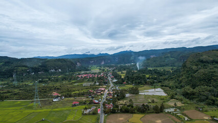 Fototapeta na wymiar Aerial view of a beautiful landscape view of Harau Valley with mountains valley and grass view, Beautiful Minangkabau. 