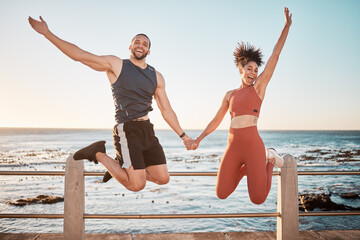 Fitness, energy and portrait of a couple jumping at beach for training fun, support and celebration...