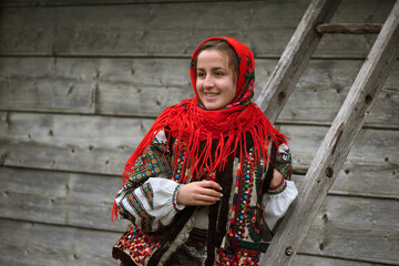 Ukrainian hutsul woman in authentic national costume sitting on