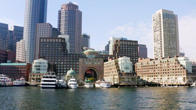 Low drone shot of Boston skyline from Boston harbor