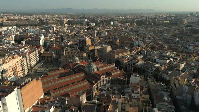 Orbiting Aerial shot of Valencia central market and old town, Spain