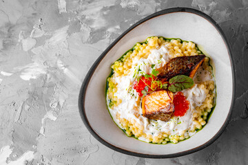 grilled salmon fish fillet with creamy ptitim, cheese and caviar