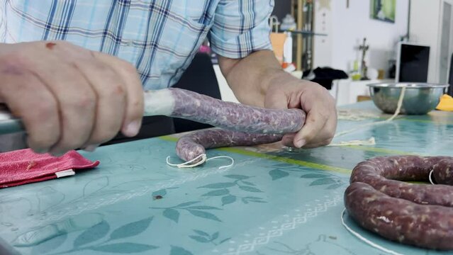 Make sausage with your sausage machine. The sausage meat is pushed into the animal intestine and thus is made eat