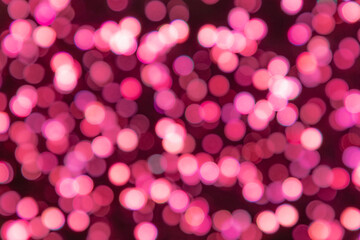 Background from lingonberry colour blurred confetti on a dark background with red shadows (strong...