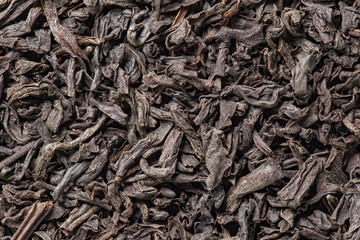 Tea, dried leaves, background uniform texture, bunch in bulk, close-up macro top view